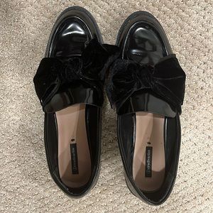 Black loafers with velvet bow